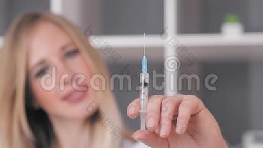 医生一位相貌出众的女士手里拿着一个注射器，从注射器中释放出多余的空气，看着